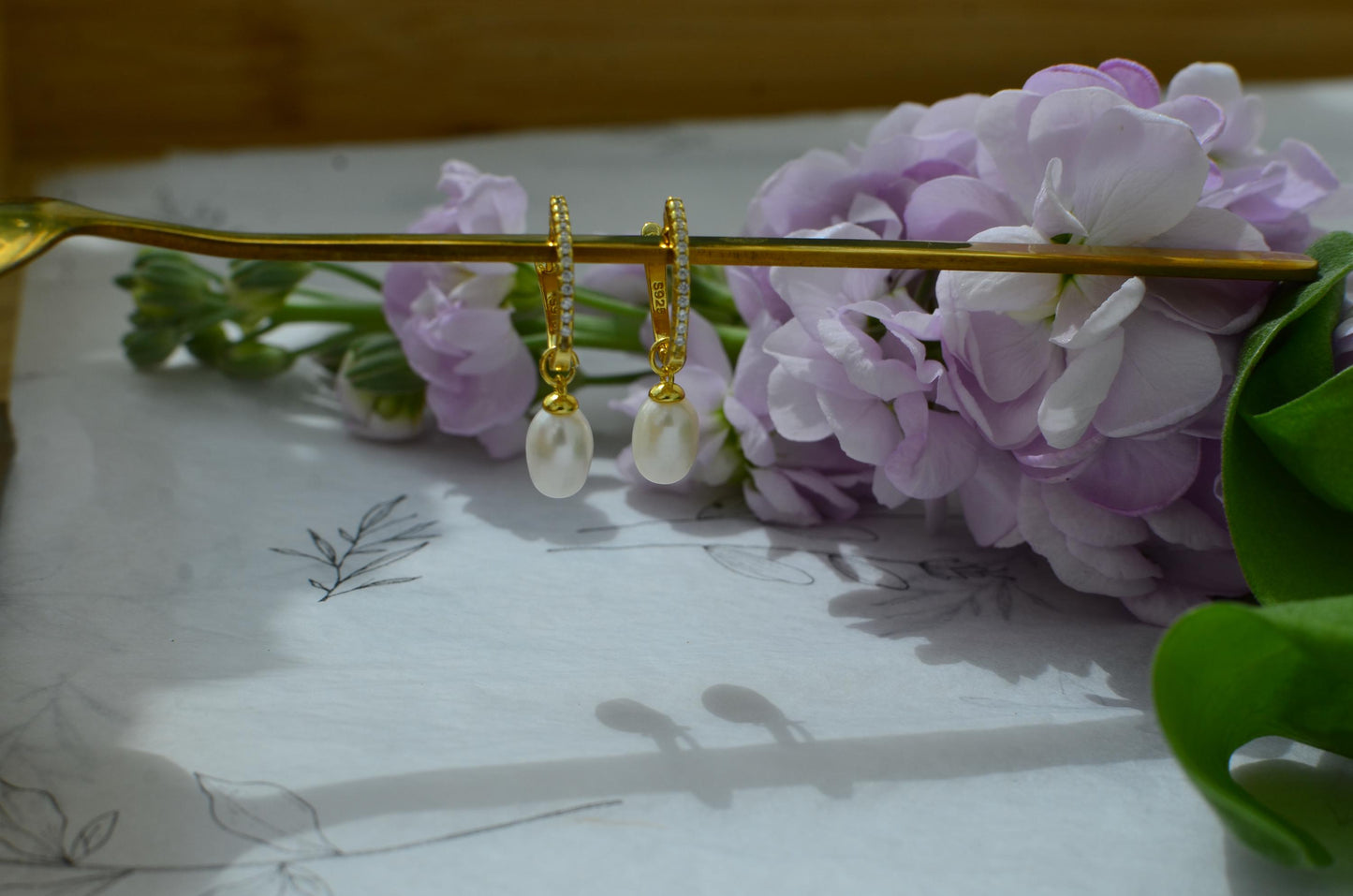 Gold Hoop Earrings with teardrop-shaped Freshwater Pearl Drop